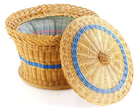 A basket woven workbox, with a blue coloured band, the removable lid enclosing a padded interior, 31cm diameter.