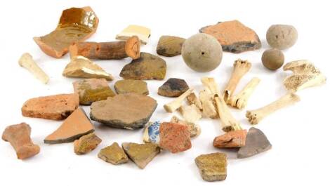 A quantity of excavated fragments of pottery, some flint balls, etc.