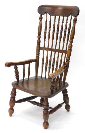 A 19thC ash and elm Windsor armchair, with a spindle turned back, shaped arms and solid seat, on turned legs with H stretcher.