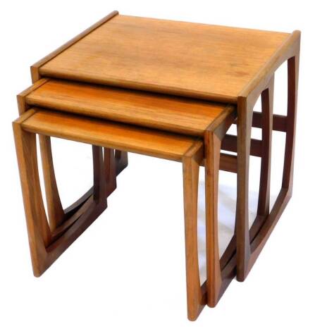 A nest of three G-plan teak tables, each of rectangular form, on end supports, the largest 53cm wide.