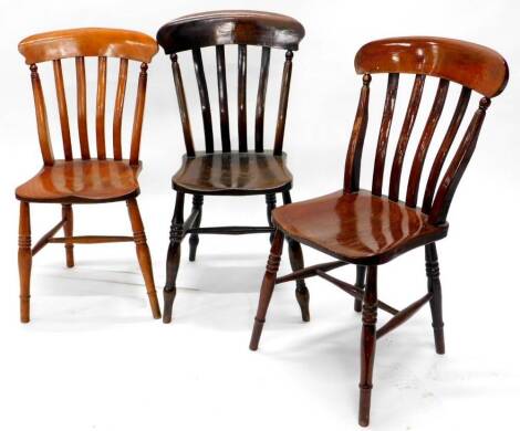 Three Windsor type kitchen chairs, each with lathe back, a solid seat on turned legs with H stretcher.