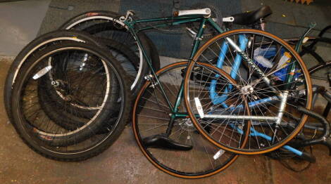 Three bicycle frames, comprising a Raleigh Pro-Race gentleman's racing bike., a Grolsch bike frame, and a DMR Bikes frame, together with assorted tyres. (a quantity)