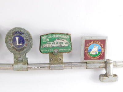 A car badge bar holding five badges, for RAC., Caravan Club., Lion's International., British Caravanner's Club., and The Camping Club. - 2