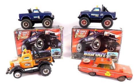 A Milton Bradley Big Foot four wheel drive truck, and another, both boxed, together with a Playskool Giant Puller Tow Vehicle, and a Daiya Japanese tin plate FD Fire Chief car, with siren. (4)