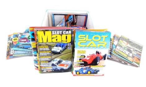 Scalextric Club Magazines, and further ephemera, in a Scalextric box.