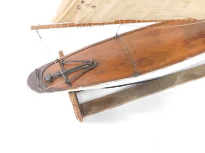 A wooden scale model of a single masted yacht, fully rigged, on a stand, 138cm wide. - 2