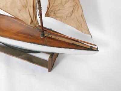 A wooden scale model of a single masted yacht, fully rigged, on a stand, 138cm wide. - 3