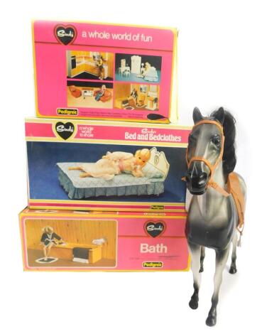 A Sindy bed and bed clothes, bath, Winter Sports, all boxed, together with a two door wardrobe and a horse. (5)