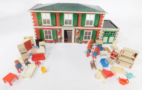 A Mettoy mid century tin plate doll's house, with open back, enclosing five rooms and a garage, 60cm wide, together with dolls house furniture.