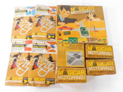 Tri-ang Go Magicar Motoring, box set MG2, together with a Criss Cross Flying Figure Eight Roadway pack, four roadway sections, two boxes of straights and a box of curved track. (9)