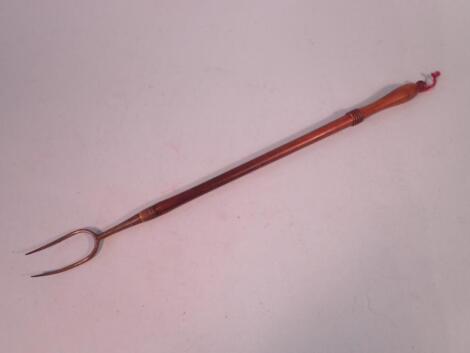 An early 19thC turned fruit wood and steel toasting fork