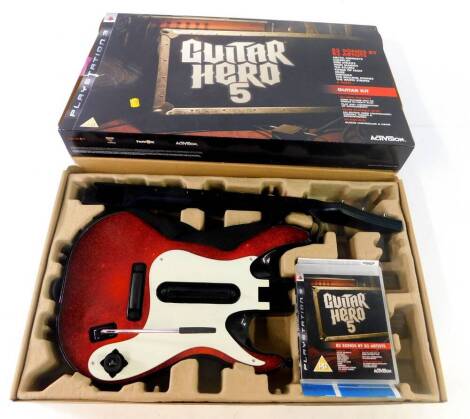 A Playstation 3 Guitar Hero 5 bundle, comprising software game, guitar controller and adapter, all boxed.