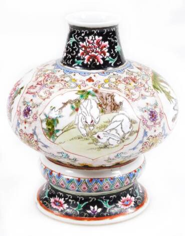 A Chinese porcelain vase, of compressed baluster form, hand painted with panels of cats, flowers and trees, broken by fixed areas of flower heads and scrolls in raised enamels, on a circular turquoise foot with double line rounded square Yongzheng mark to