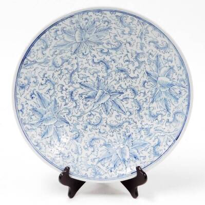 A Chinese blue and white porcelain charger, with scrolling leaf decoration, probably 19thC, 37cm diameter.