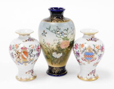 A Japanese Satsuma baluster vase, decorated with panels of peonies, wisteria and birds, 15cm high, and a pair of Samson Chinese armorial baluster vases, 12cm high.