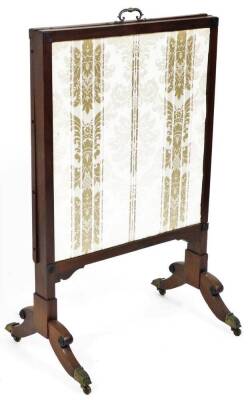 A 19thC mahogany articulated fire screen, with adjustable central section centred by a brass handle, of overall part embroidered form, raised on scroll supports terminating in brass caps and castors, when closed 66cm wide, 48cm deep, 110cm high. (AF)