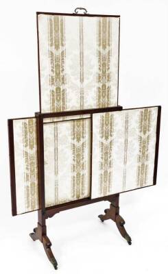 A 19thC mahogany articulated fire screen, with adjustable central section centred by a brass handle, of overall part embroidered form, raised on scroll supports terminating in brass caps and castors, when closed 66cm wide, 48cm deep, 110cm high. (AF) - 2