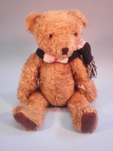 A teddy bear made by Cripplecraft with cloth label and brown