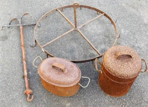 A Victorian wrought iron game hanger, another and two metal cook pots.