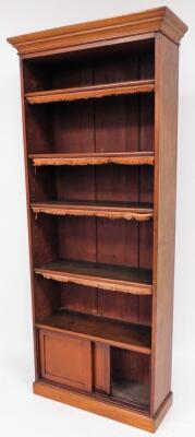 A Victorian mahogany open bookcase, with moulded cornice and adjustable shelves with tassels over a sliding door base on plinth, 209cm high, 84cm wide, 30cm deep. - 2