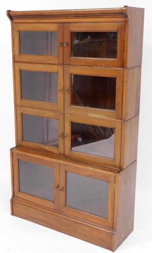 An early 20thC walnut Minty style stacking bookcase, with glazed doors and plinth, 152cm high, 88cm wide, 31cm deep.