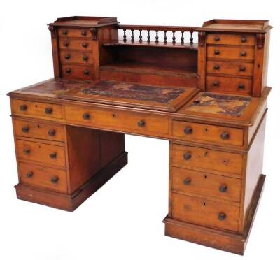 A Victorian mahogany banker's desk, with Wellington action upper drawers and gallery, lift flap centre desk section with pigeonholes inside, frieze drawers and three draws per pedestal on plinth, 117cm high, 155cm wide, 78cm deep.