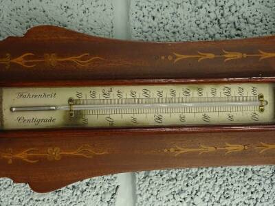 An Edwardian mahogany and marquetry wheel barometer by Dolland of London, the shaped case decorated with foliate scrolls, ribbons, etc., with an aneroid barometer and thermometer above, 85cm high. - 3