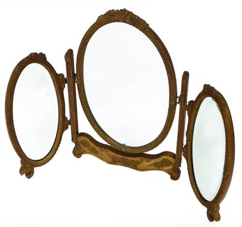 An Edwardian gilt wood and plaster triple dressing table mirror, with oval bezel plates and moulded frames, 65cm high.