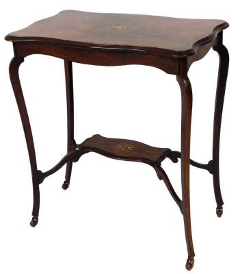 A late Victorian rosewood marquetry centre table, with moulded serpentine top and under shelf, on shaped legs with brass and ceramic castors, 73cm high, 65cm wide, 40cm deep.