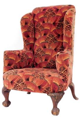 A 19thC mahogany framed high wing back armchair, upholstered in a moquette design material, having carved short cabriole legs with ball and claw feet and out splay rear cabriole legs with pad feet, 120cm high. 80cm over arms.