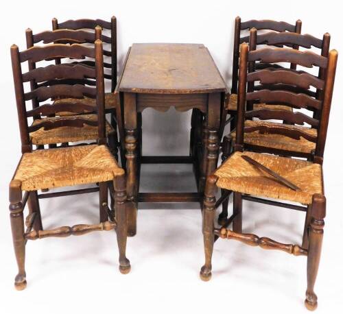 An oak country dining suite, comprising gateleg table and six ladderback chairs with rush seats.