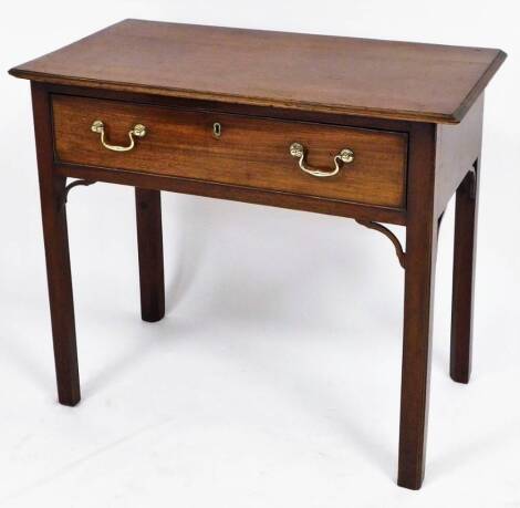 A George III mahogany side table, the plain top with beaded tapered borders, on single drawer, with two brass handles, with fret carved panels on straight legs, 70cm high, 84cm wide, 46cm deep.