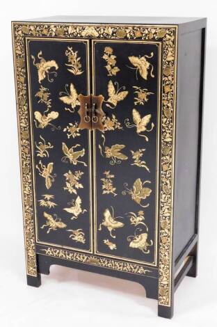 An Oriental Japanned hall cabinet, with overall gold embellished floral and butterfly design, 120cm high, 70cm wide, 40cm deep.