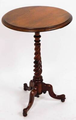 An early Victorian walnut wine table, the circular moulded top over a twist stem, on a tripod base, 73cm high, 49cm diameter.