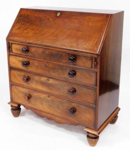 An early 19thC mahogany bureau, the fall flap opening to reveal drawers, cupboard and letters section, above four drawers, on bun feet, 121cm high, 100cm wide, 49cm deep.