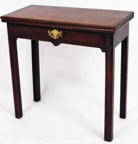 A George III mahogany card table, the top opening to reveal green baise, above single drawer, with brass back plate, on square legs, 73cm high, 75cm wide, 37cm deep when closed.