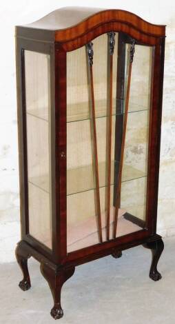 A mid 20thC display cabinet, the serpentine top raised above a panelled door, on squat cabriole legs and ball & claw feet, 129cm high, 62cm wide, 32cm deep.