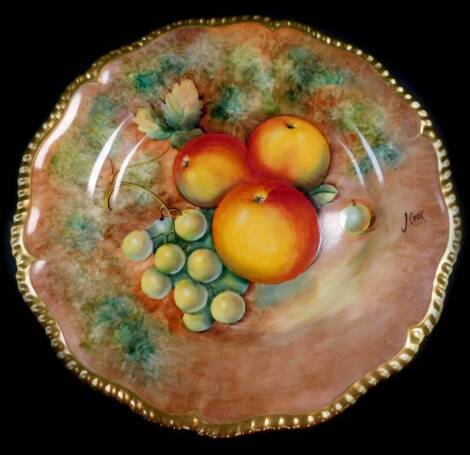 A Royal Worcester porcelain cabinet plate, signed J Cook, painted with apples and green grapes, 25cm diameter.