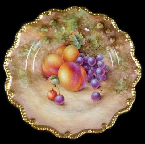 A Royal Worcester porcelain cabinet plate, signed M Johnson, painted with peaches and black grapes, 23cm diameter.