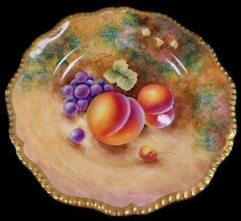 A Royal Worcester porcelain cabinet plate, signed Leaman, painted with peaches and black grapes, 22cm diameter.