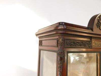 A late 19thC Louis XVI style mahogany vitrine, with metal mounts, the domed pediment cast centrally with musical instruments and flowers, over a frieze set with a panel of putti, flanked by scrolling flowers above two glazed doors, set with astragal glass - 3