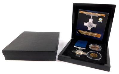 A Bradford Exchange George Cross gold and silver proof set, comprising a replica George Cross medal., 9ct gold Elizabeth II double crown, and a silver crown, boxed with certificate.