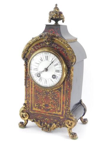 A French late 19thC Boulle mantel clock, circular enamel dial bearing Roman and Arabic numerals, eight day movement with coil strike, stamped Fabrique de Paris., the case cast with a bowl of fruit finial, mask and scrolling leaves, raised on cabriole legs