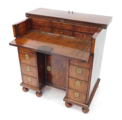 An early 18thC and later adapted walnut kneehole bachelor's secretaire chest, with folding top and raised on bun feet, 87cm high, 87cm wide, 58cm deep. - 6