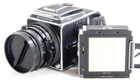 A Hasselblad 503CX camera, with Zeiss Planar f2.8 80mm lens, two A12 film backs and lens hood, in a camera bag.