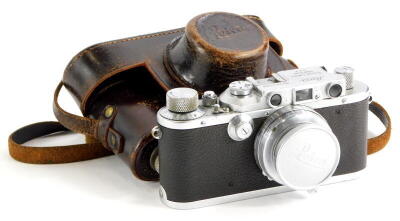 A Leica III camera, serial number 163566, with a Leitz 5cm f2 Summar lens, number 403494, in a leather case.