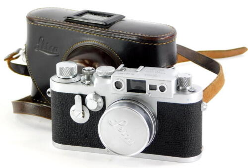 A Leica IIIG camera, serial number 981064, with a Leitz 5cm f2.8 Elmar lens, number 1619673, in a leather case.