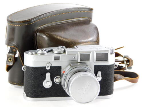 A Leica M3 single wind camera, serial number 1111501, with a Leitz 50mm f2 Summicron lens, number 2053800, in a leather case.