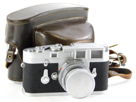 A Leica M3 single wind camera, serial number 1111501, with a Leitz 50mm f2 Summicron lens, number 2053800, in a leather case.