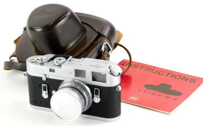 A Leica M4 camera, serial number 1270524, with a Leitz 5cm f2 Summicron lens, number 1156983, in a leather case.